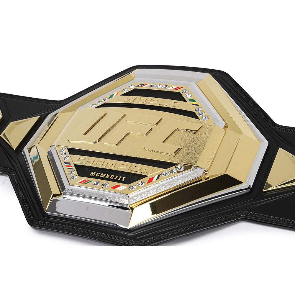 Close-up of UFC legacy replica belt with gold and black detailing from Champions Forge